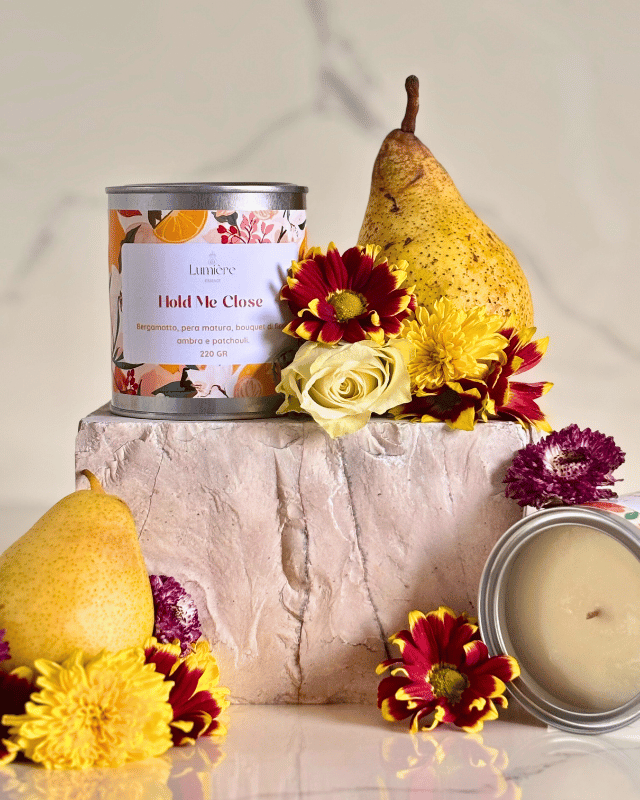 Candela su una pietra di marmo in cera di cocco con pere e fiori dal profumo floreale e fruttato 