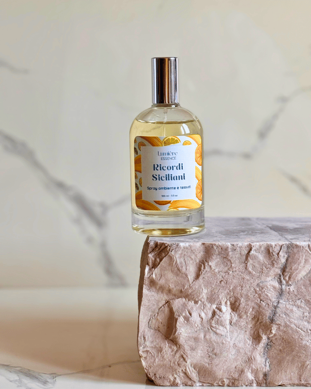 Spray per ambienti e tessuti in bottiglietta di vetro su pietra di marmo