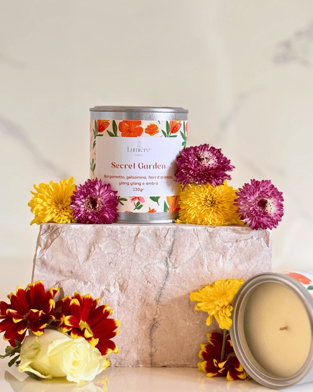 Candela in barattolo con fiori e profumo floreale su pietra di marmo e candela aperta con interno visibile