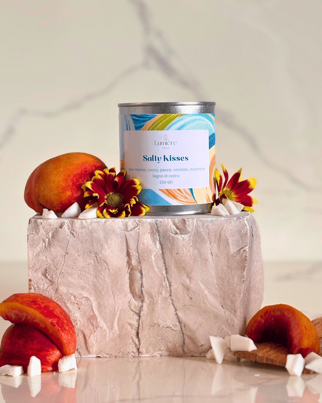 candela in barattolo di latta con decorazioni floreali  su pietra di marmo